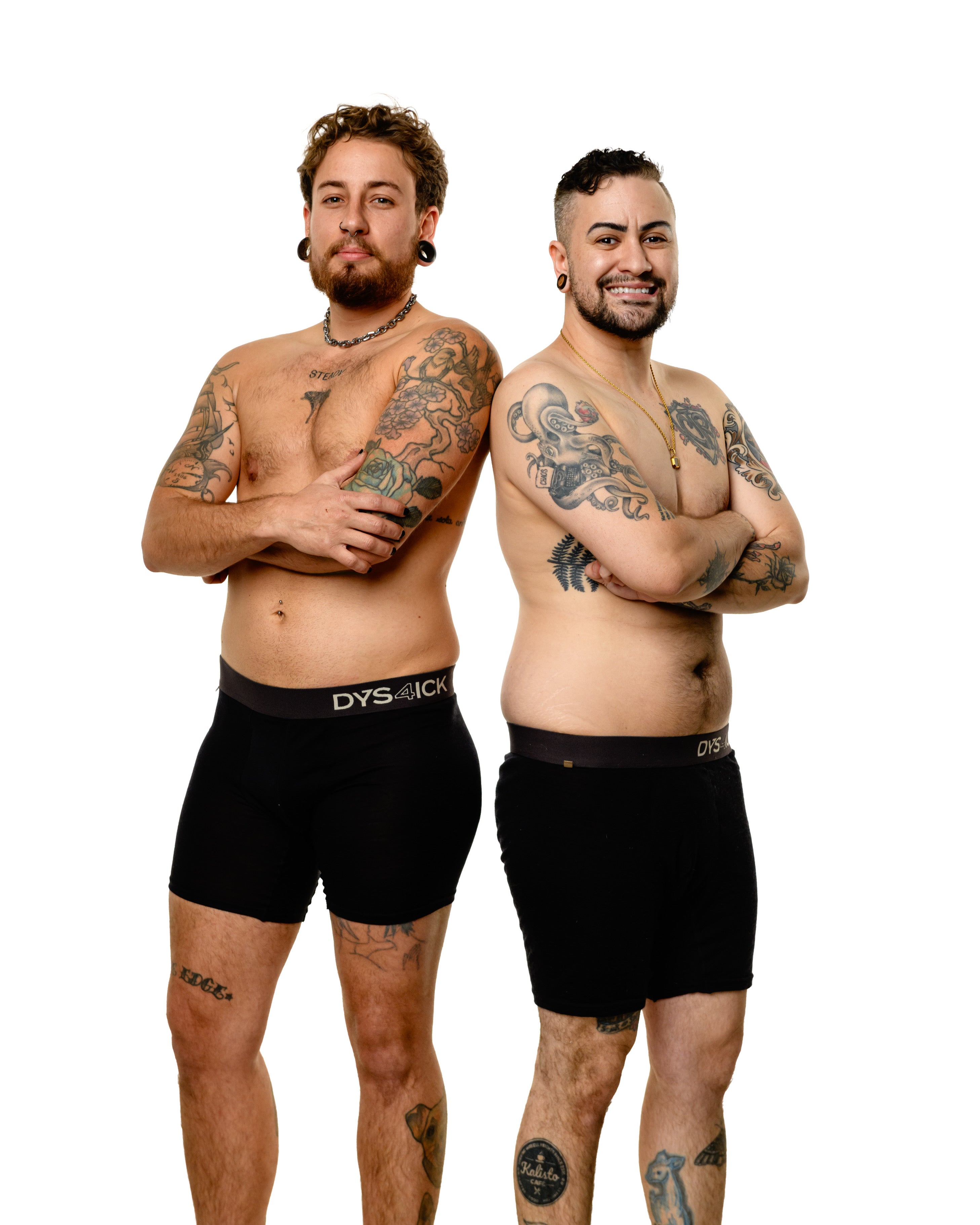 Two tattooed trans men standing back-to-back wearing black Dys4ick limited edition Australian merino wool packing boxers with contrast waistband