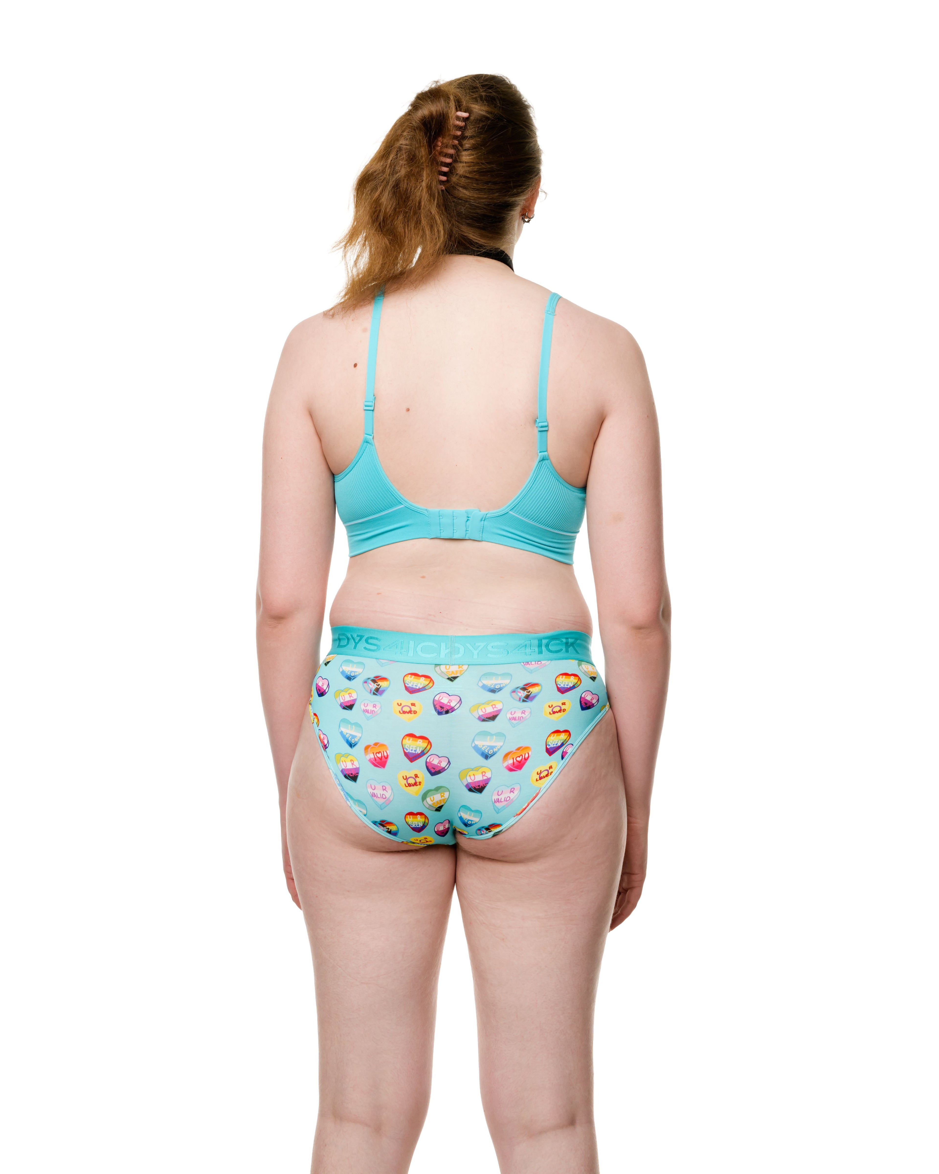 Back view of Alt trans woman model wearing pride MTF tucking panties wearing Dys4ick gender-affirming underwear, inclusive transgender underwear designed in Australia for trans and nonbinary bodies.