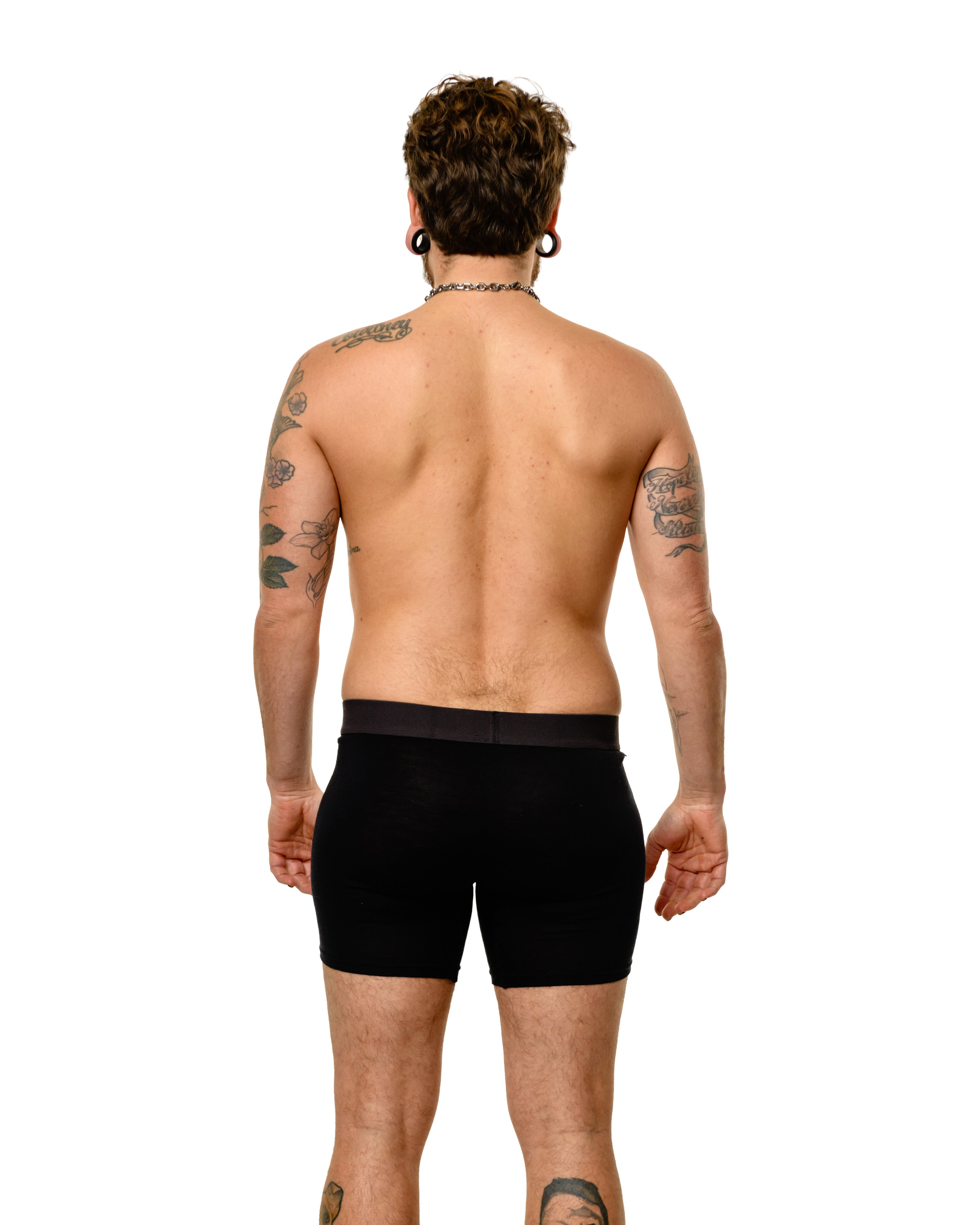 Rear view of Transmasculine model wearing Dys4ick limited edition packing boxers in 100% Australian merino wool, gender-affirming underwear for trans men